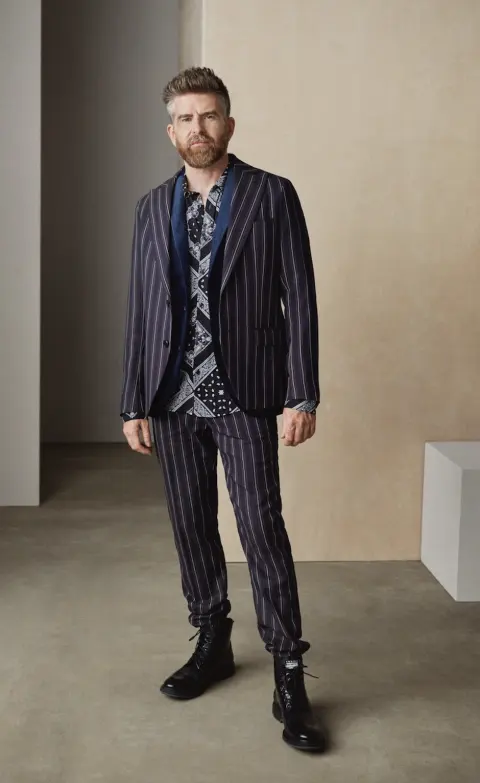 Phil Alderson modelling a patterned navy suit