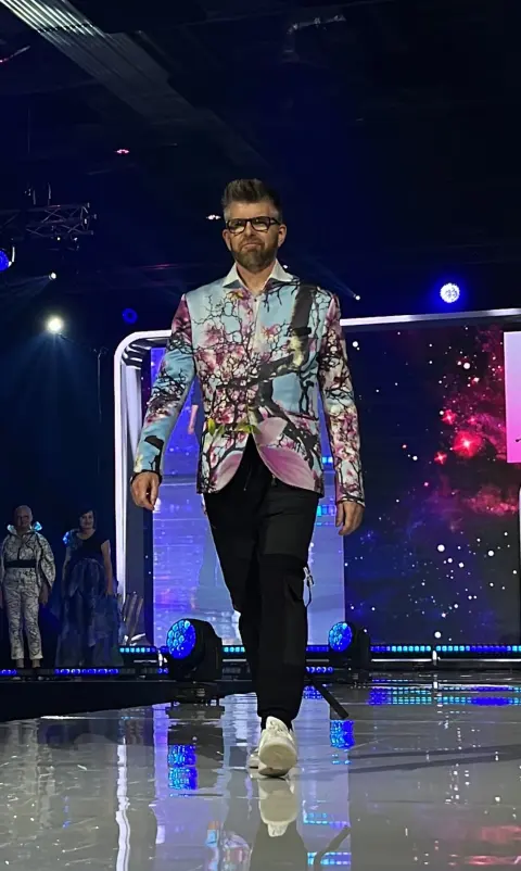 Phil Alderson walking on a fashion runway