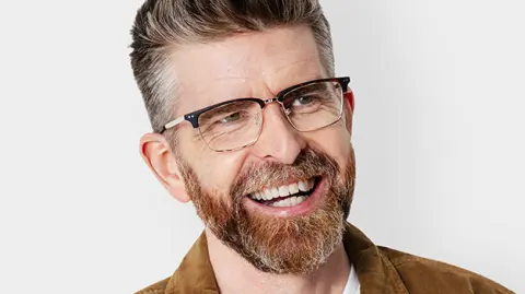 Phil Alderson smiling in a commercial portrait